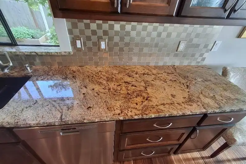 Resurfaced granite countertop with a high-gloss finish reflecting the tile backsplash, Camano Island