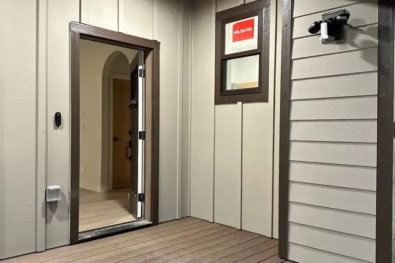 Front entry of a new home with a cedar porch ceiling, recessed light, board-and-batten siding and composite steps, Stanwood