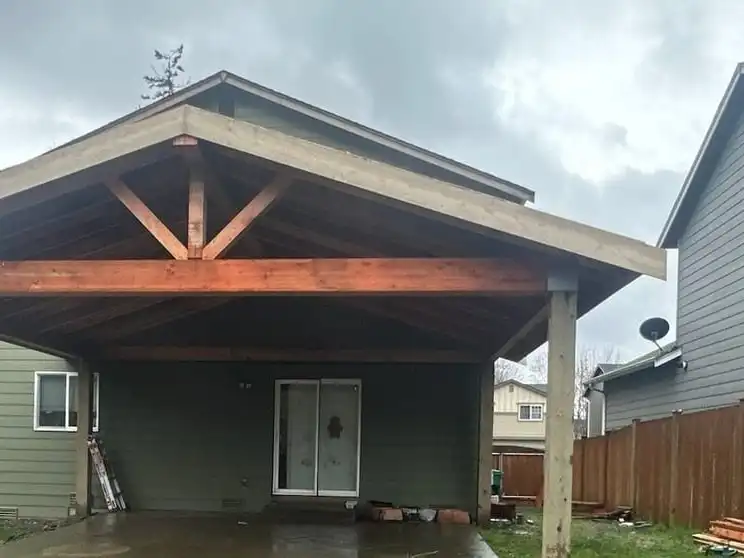 Gable patio cover with an exposed truss and glulam beam over a backyard patio, Marysville